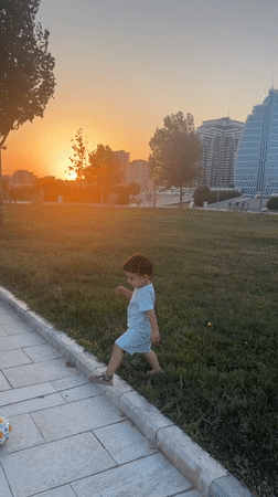 Sunset stroll along Baku's Caspian promenade with dogs and kids