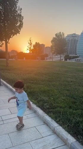 Sunset stroll along Baku's Caspian promenade with dogs and kids