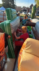 Kids tackle a western-themed inflatable obstacle course outdoors