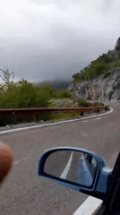 Vehicle travels winding mountain road in Brda, Montenegro