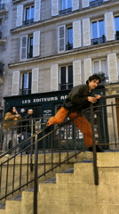 Man slides down staircase railing in Paris