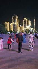 Evening family activity captured in illuminated Grozny public square