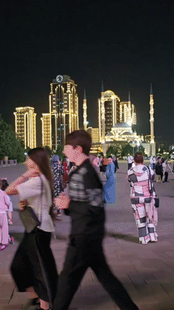 Evening family activity captured in illuminated Grozny public square