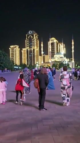 Evening family activity captured in illuminated Grozny public square