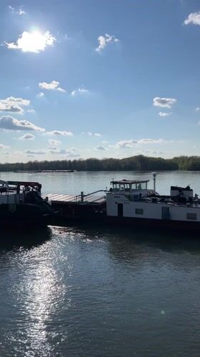 Boats navigate Danube River at Ruse under sunny skies
