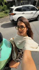 Woman films selfie video while riding motorcycle in Bali