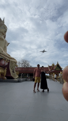 Tourists visit golden Buddha temple in coastal Thai fishing village