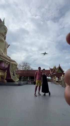 Tourists visit golden Buddha temple in coastal Thai fishing village