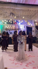 Wedding reception features bride dancing amid scattered currency notes