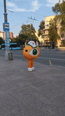 Orange one-eyed mascot spotted at a Yekaterinburg bus stop