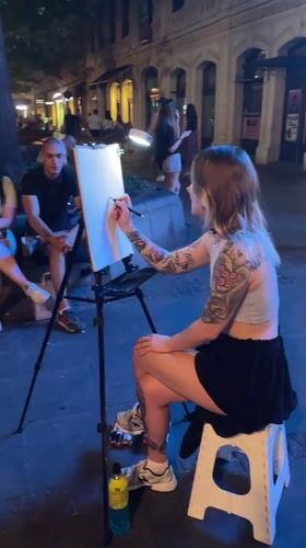 Street caricature artist at work on a Belgrade summer night