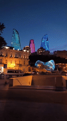 Evening cityscape captured in Baku featuring illuminated Flame Towers