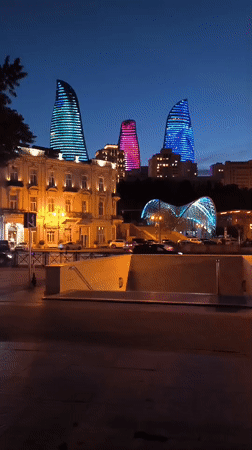 Evening cityscape captured in Baku featuring illuminated Flame Towers