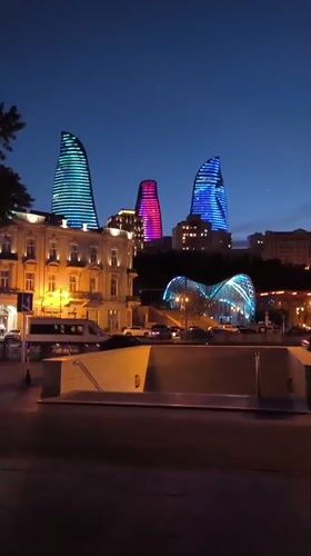 Evening cityscape captured in Baku featuring illuminated Flame Towers