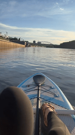 Afternoon on the Tura River — paddleboards, boats, and riverside chill
