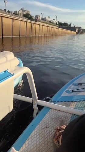 Afternoon on the Tura River — paddleboards, boats, and riverside chill