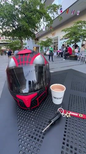 Coffee and helmet on a table outside a Maracay shopping strip