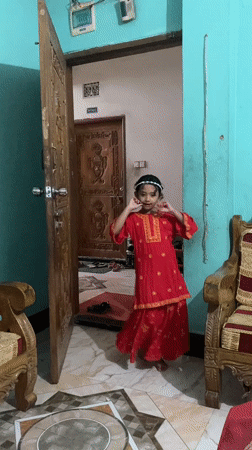 Red dress, teal room: multiple angles on a Dhaka morning