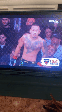Person watches UFC fight on tablet in Paris