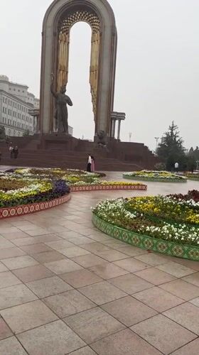 Rainy morning walk documented through ornate Dushanbe public park