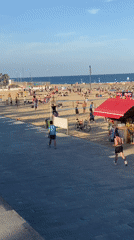 Sunny afternoon beach activity documented in Barcelona
