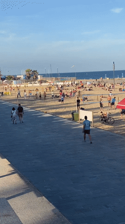 Sunny afternoon beach activity documented in Barcelona