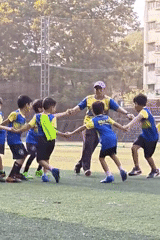 Children play soccer and rollerblade at Mumbai school playground