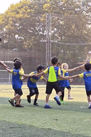Children play soccer and rollerblade at Mumbai school playground