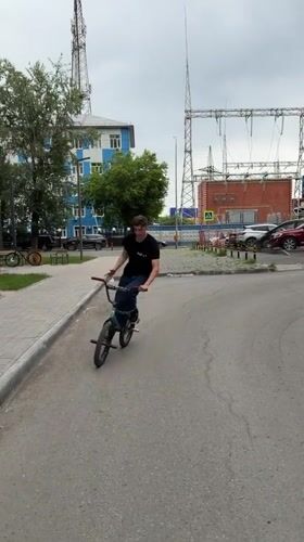 Cyclist rides BMX bike through Tyumen streets