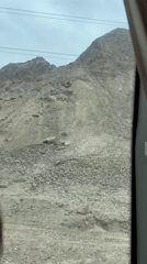 Vehicle travels through rocky mountain landscape in Guazhou County