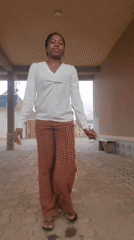 Woman creates selfie content in covered walkway, Nigeria