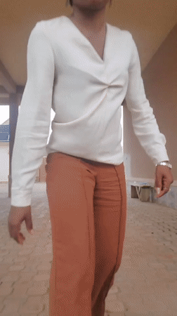 Woman creates selfie content in covered walkway, Nigeria