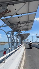First-person ride across a sunny Bali bridge