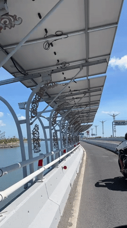 First-person ride across a sunny Bali bridge