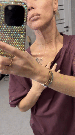 Woman documents rhinestone craft project in Abakan, Russia