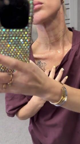 Woman documents rhinestone craft project in Abakan, Russia
