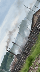 Rural Russian village shows industrial smoke amid pastoral scenes