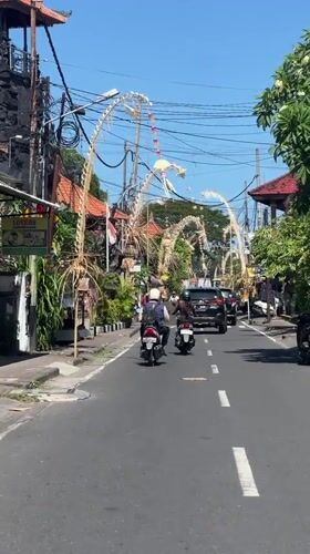 Scooter ride through festive, decoration-lined streets of Kuta Selatan