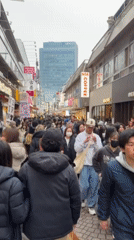 Winter crowds fill narrow Shibuya street during morning hours