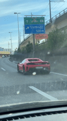 Red Ferrari spotted on roadway in Kloten, Switzerland