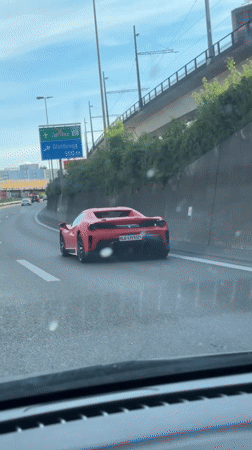 Red Ferrari spotted on roadway in Kloten, Switzerland