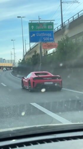 Red Ferrari spotted on roadway in Kloten, Switzerland
