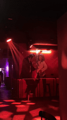 Red-lit bar interior with dance mural observed in Saratov