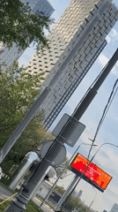 Woman paints lamppost near damaged security booth in Moscow