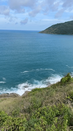 Rawai coastline views: rocky cliffs, blue water, offshore island