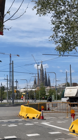 Tram crosses Barcelona street near Sagrada Familia