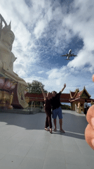 Posing in front of a golden Buddha statue in Ko Samui