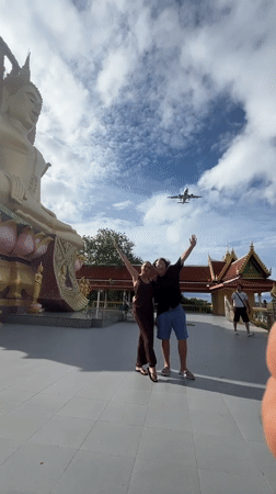 Posing in front of a golden Buddha statue in Ko Samui
