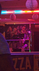 Live DJ set underway at a neon-lit bar in Hévíz