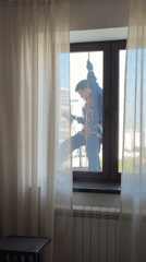 Worker performs high-rise maintenance in Khimki, Russia